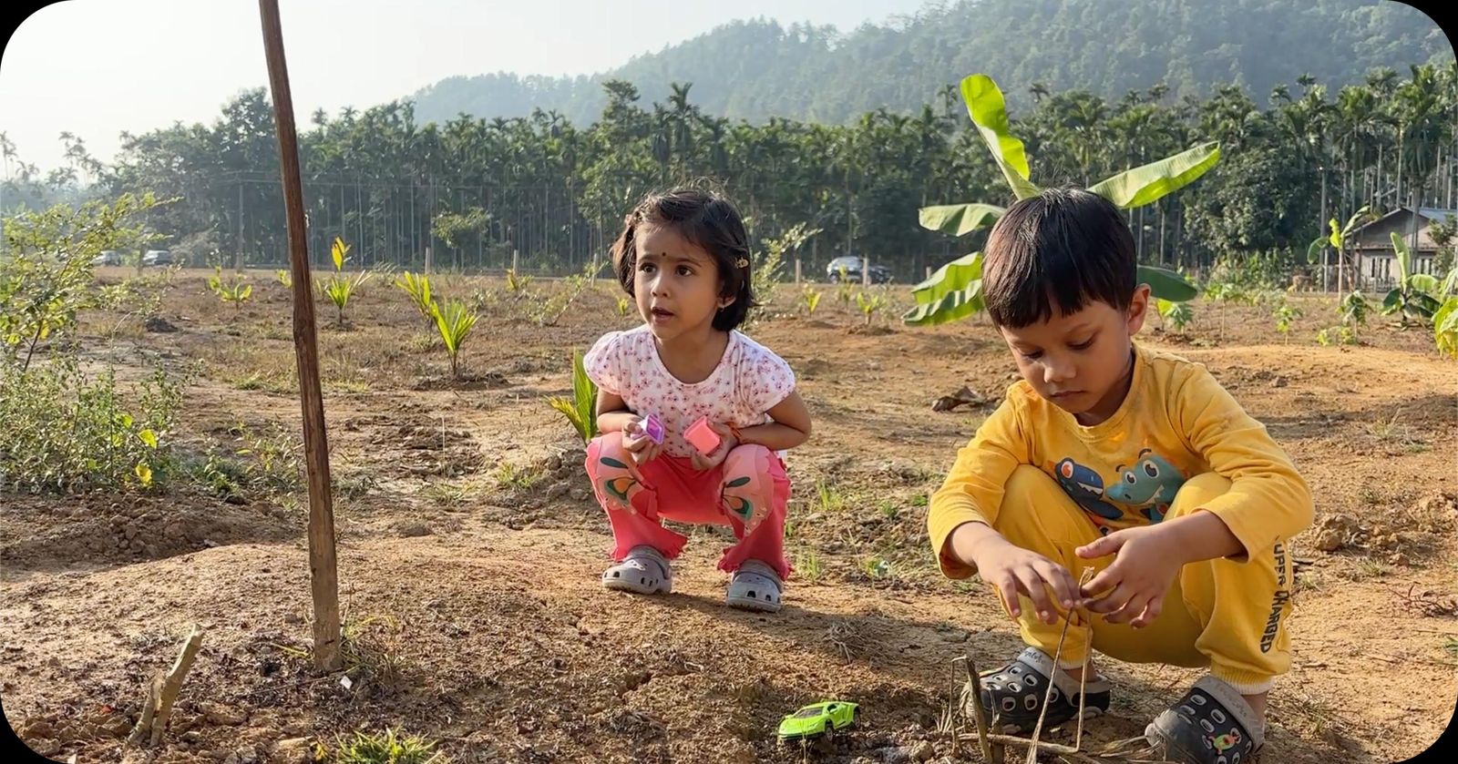 Two children planting seedlings at the Umsur farm